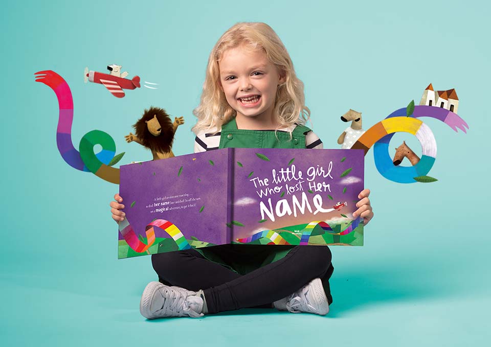 girl holding a copy of the little girl who lost her name