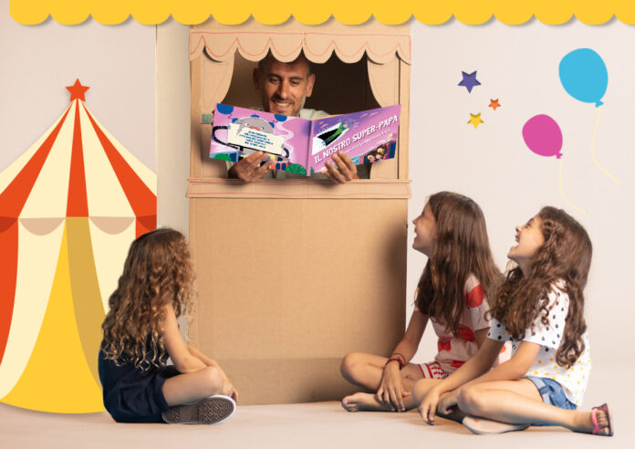 2022_Family_Reading_Blog_Section_3_IT papà che legge un libro personalizzato alle sue tre figlie