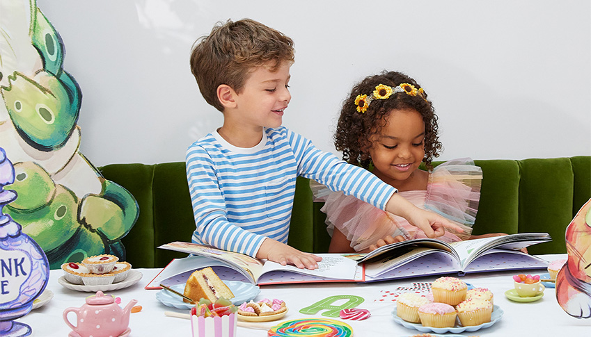 children reading wonderbly books around a table