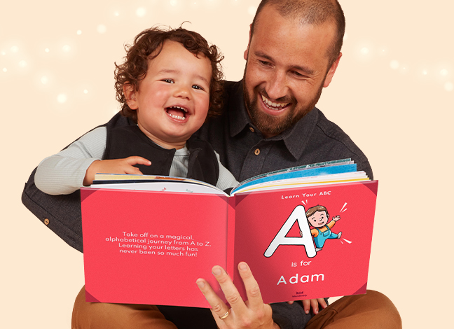 Image of a dad reading a personalised Wonderbly book to his son