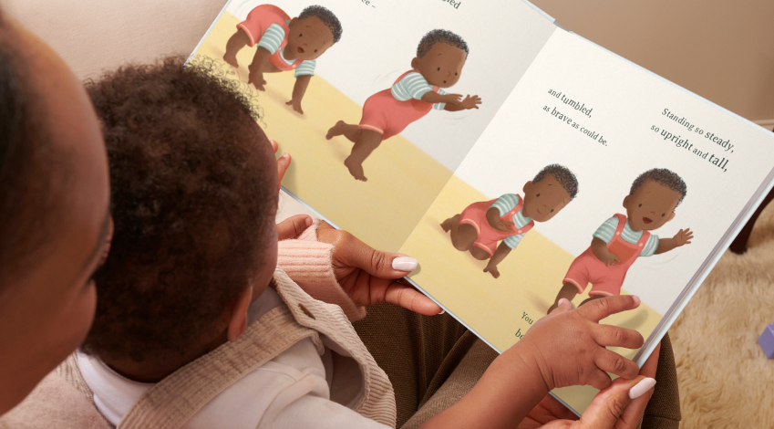 parent and child reading a book with a baby learning to crawl and walk