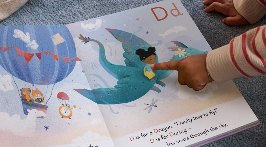 photo of wonderbly book with a girl riding a flying dinosaur